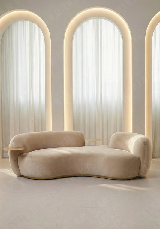 Bera sofa in beige velvet upholstery with integrated side table and curved low profile design