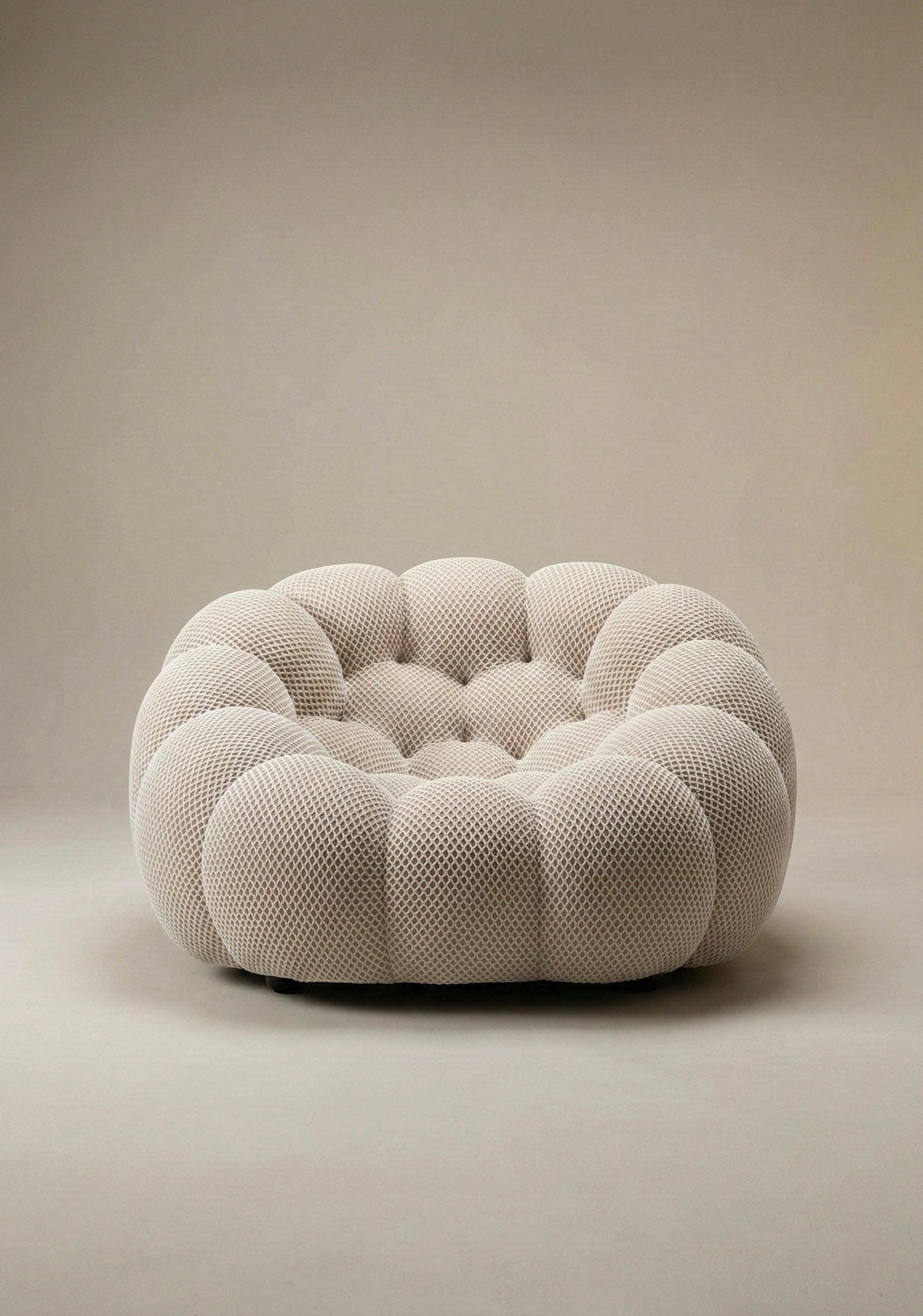 Benna Cloud Chair in beige mesh upholstery with plush, rounded cushions
