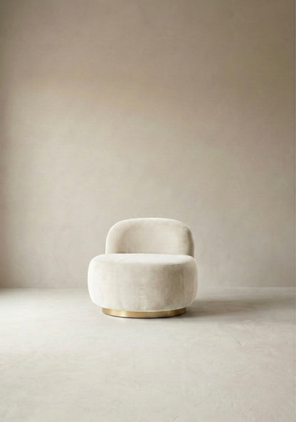 Modern chair with curved backrest in a minimalistic room with light-coloured walls and floor.