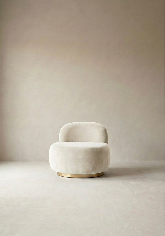 Modern chair with curved backrest in a minimalistic room with light-coloured walls and floor.