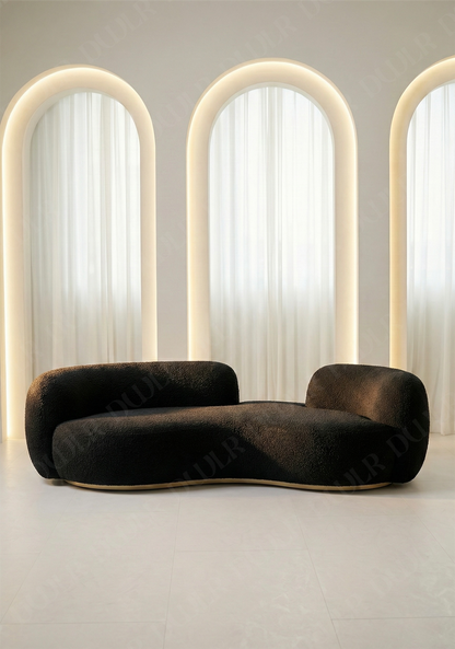 Bera sofa in black boucle upholstery with curved silhouette and low profile design, without integrated side table