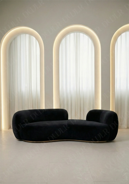 Bera sofa in black velvet upholstery with curved silhouette and low profile design, without integrated side table