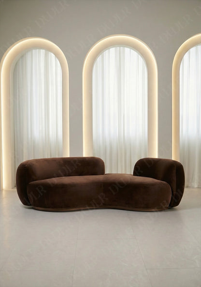 Bera sofa in brown velvet upholstery with curved silhouette and low profile design, without integrated side table