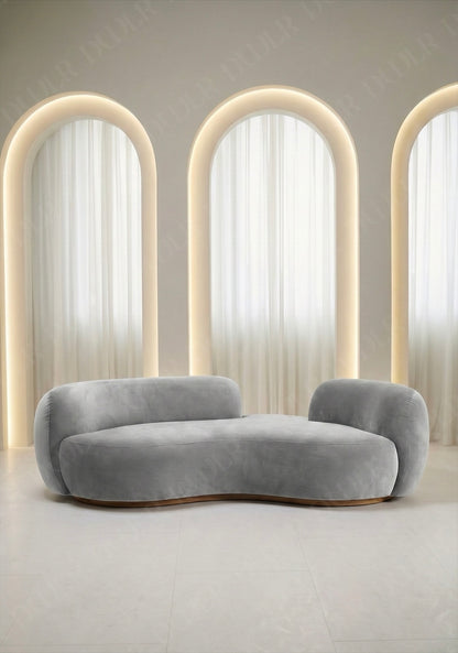 Bera sofa in light grey velvet upholstery with curved silhouette and low profile design, without integrated side table