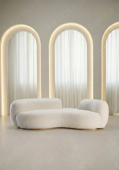 Bera sofa in off white boucle upholstery with curved silhouette and low profile design, without integrated side table