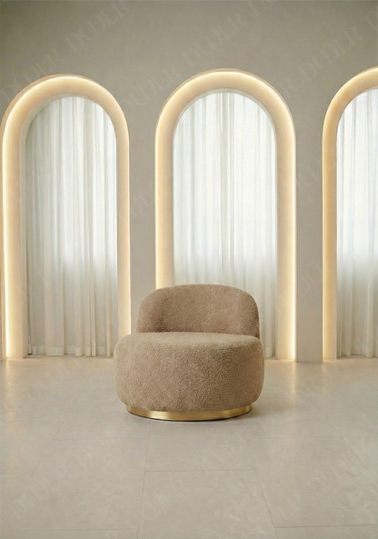 Beige armchair in a room with three arch-shaped light fixtures.