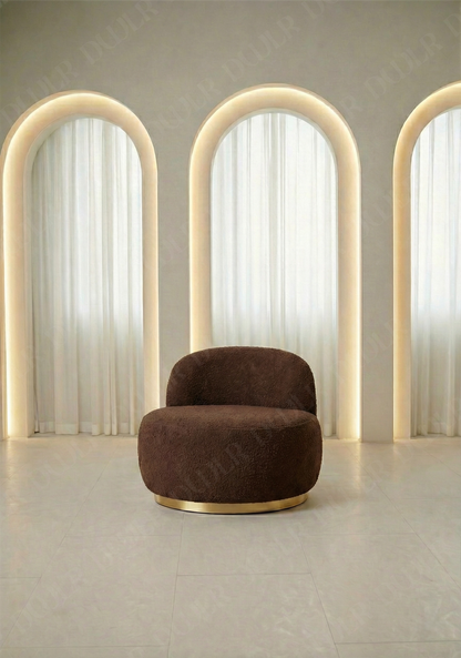 Modern brown armchair in a room with arch-shaped light fixtures.