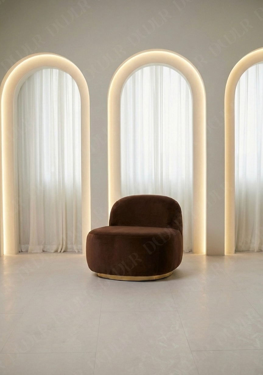 Brown armchair in a room with three arch-shaped light fixtures.