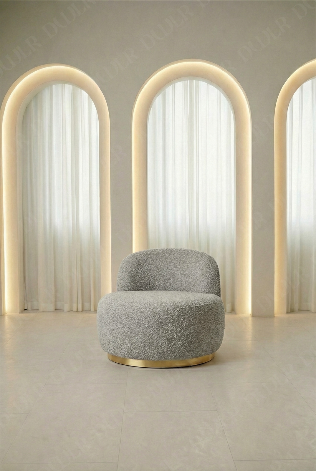 Gray armchair in a room with arch-shaped light fixtures and white curtains.