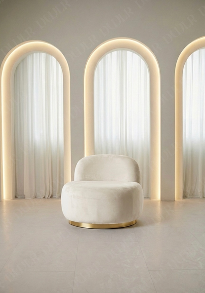 Modern chair with curved backrest in a minimalistic room with light-colored walls and floor.