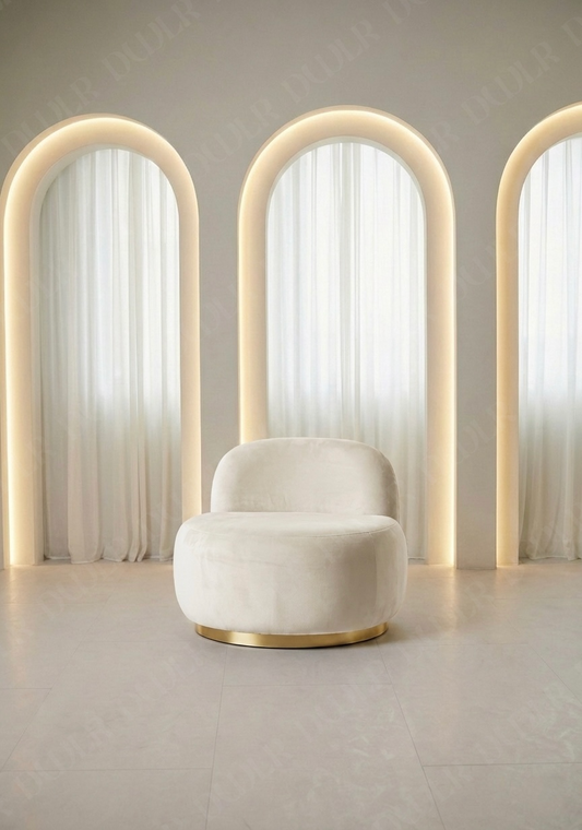 Modern chair with curved backrest in a minimalistic room with light-colored walls and floor.