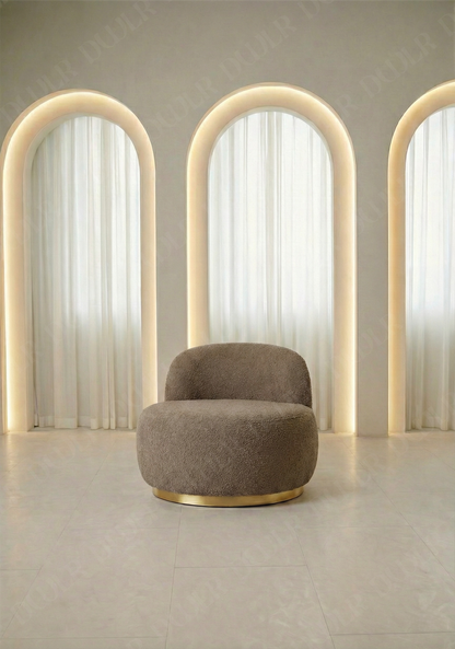 Modern brown chair with gold base in front of three illuminated arches.