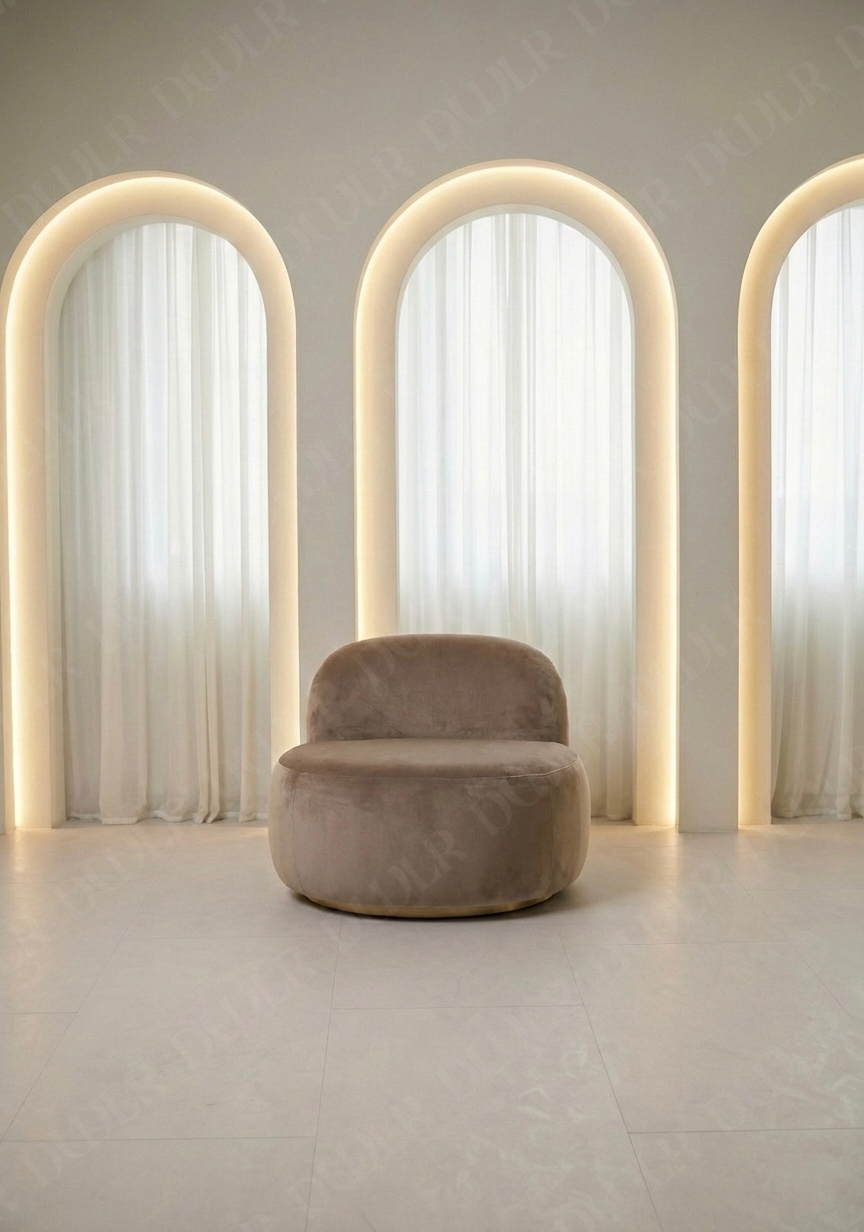 Modern chair in a room with three arch-shaped light fixtures.