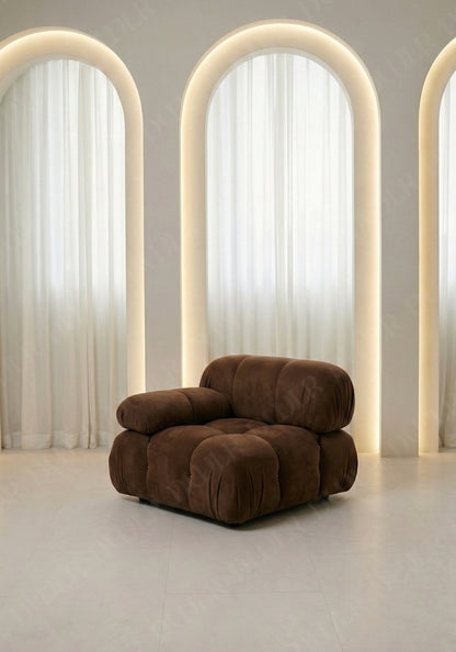 Cierra modular seat with backrest and low armrest in brown suede upholstery designed for flexible seating layouts