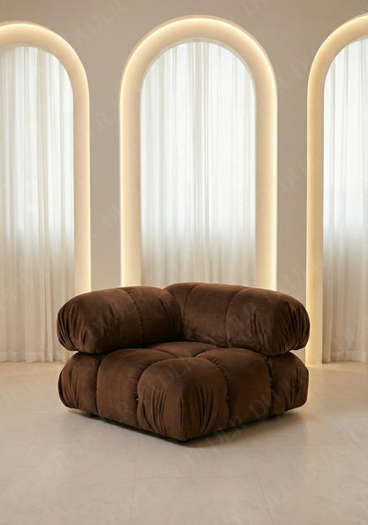 Cierra modular seat with backrest and high armrest in brown velvet upholstery designed for flexible seating layouts