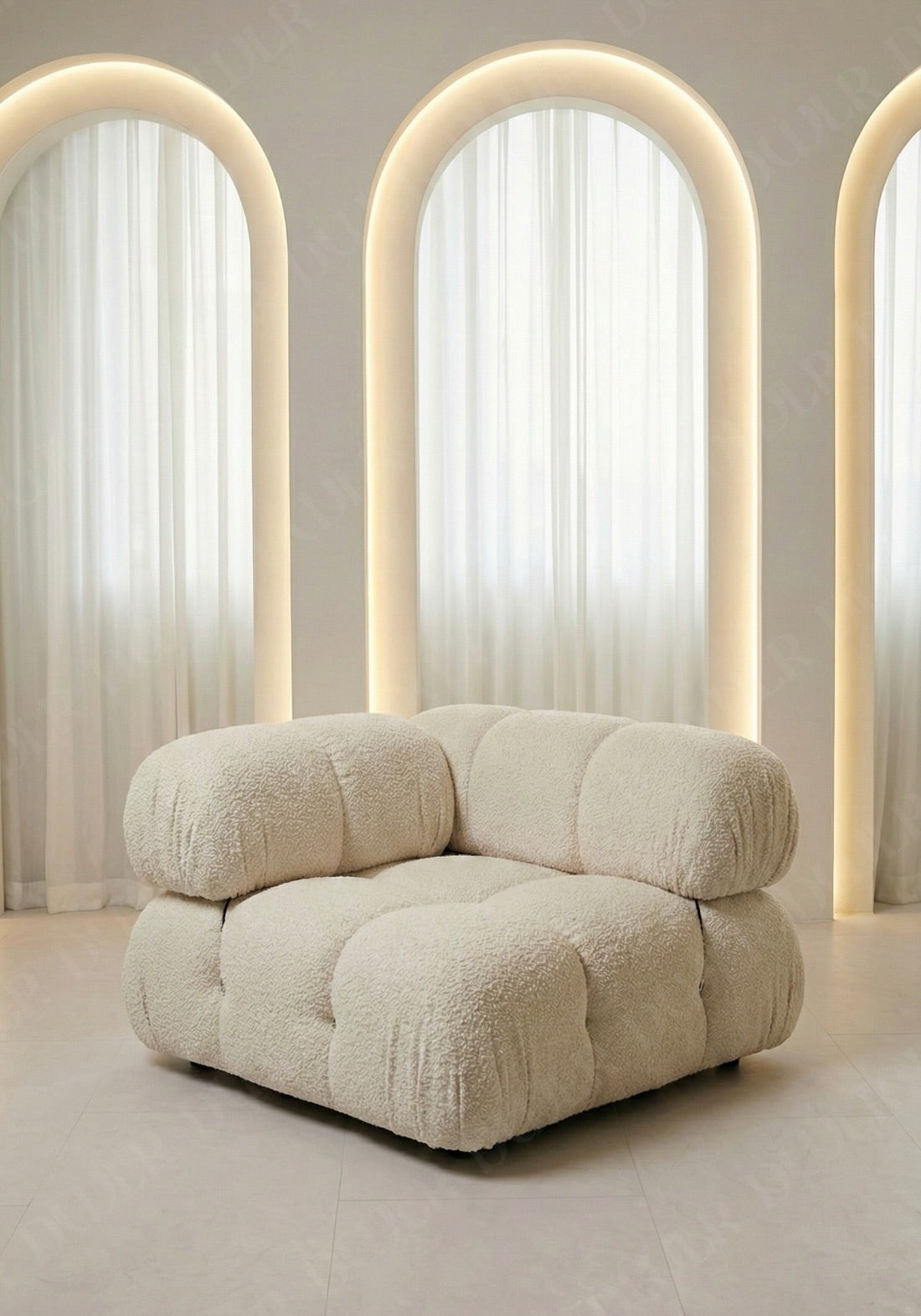 Cierra modular seat with backrest and high armrest in off white boucle upholstery designed for flexible seating layouts