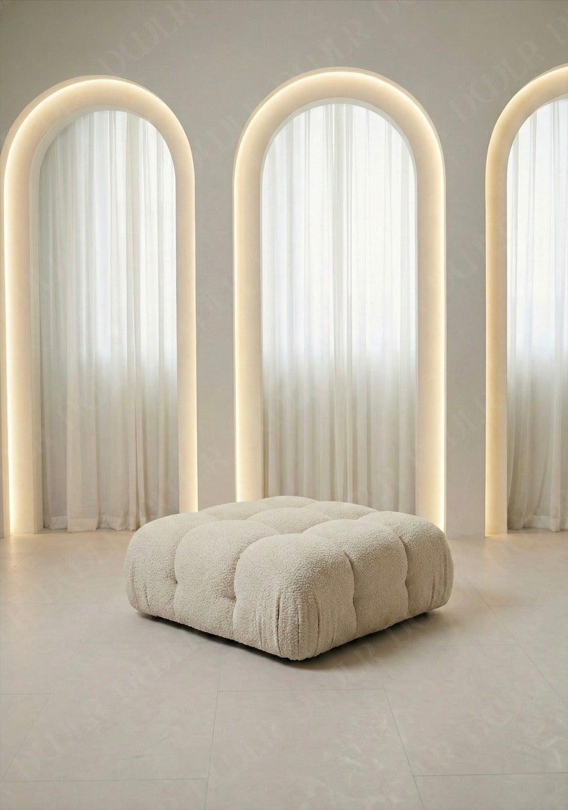 Cierra modular ottoman upholstered in off white boucle fabric designed to be used as footrest or seating extension