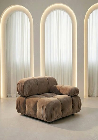 Cierra modular seat with backrest and low armrest in taupe upholstery designed for flexible seating layouts