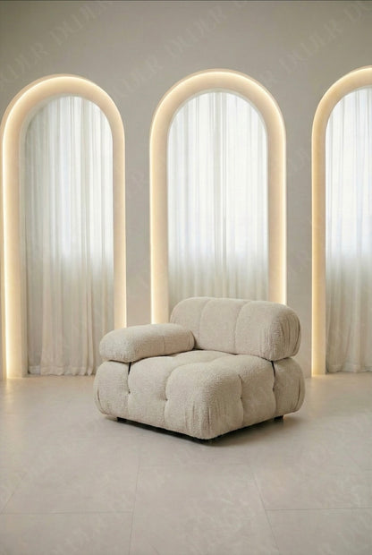 Cierra modular middle seat with backrest and armrest in off white boucle upholstery designed for flexible seating layouts