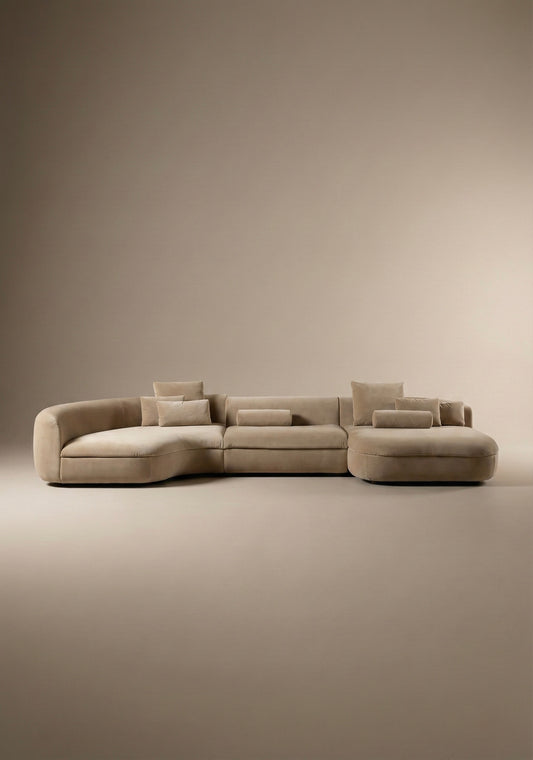 Large curved modular sofa in beige  velvet upholstery with sculptural form and modular layout