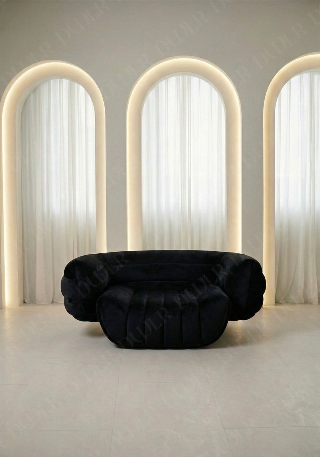 Black sofa in a room with three arched light fixtures and white curtains.