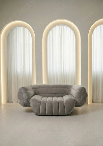 Gray sofa in a room with arches and soft lighting