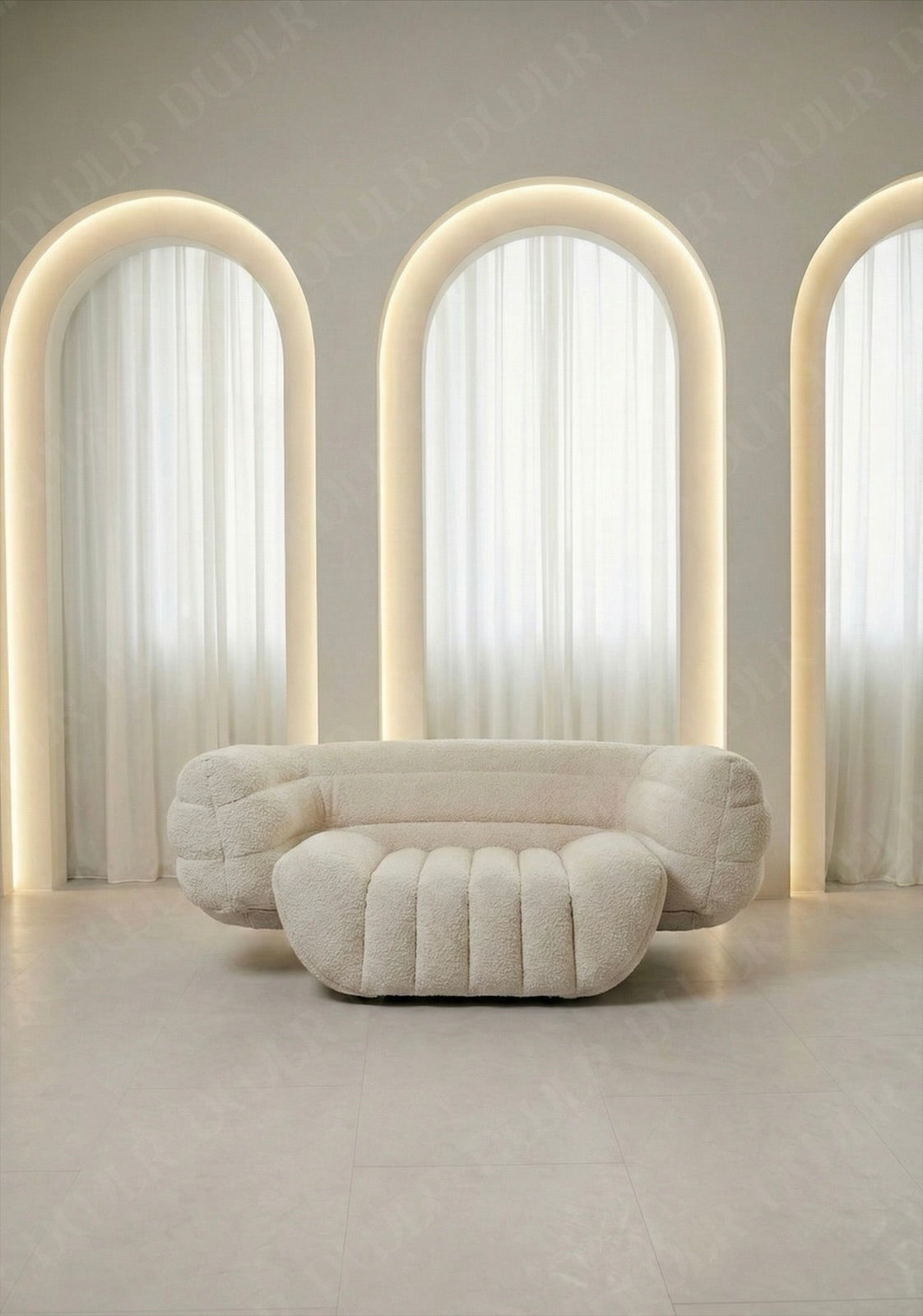 Modern beige sofa in a room with three arched windows and soft lighting