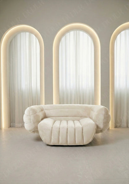 Modern white sofa in a room with arch-shaped light fixtures.