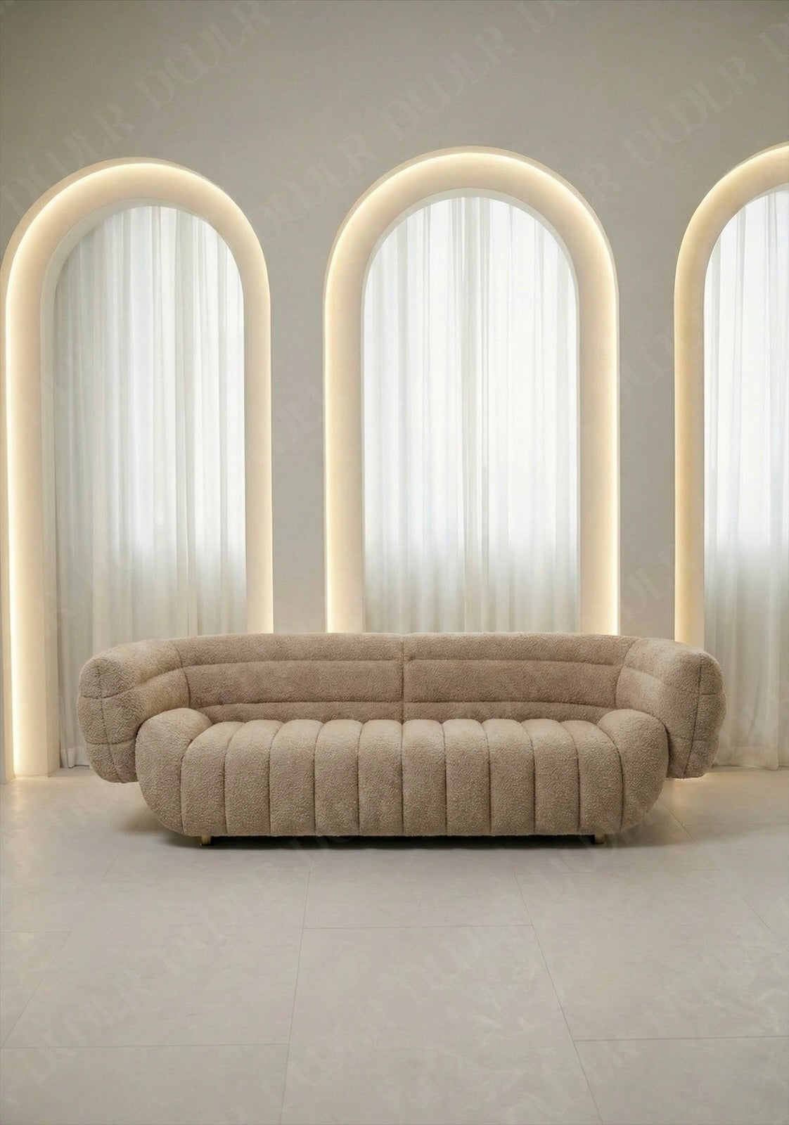 Solara sofa in beige boucle upholstery with curved silhouette and channel tufted seat in modern living room.